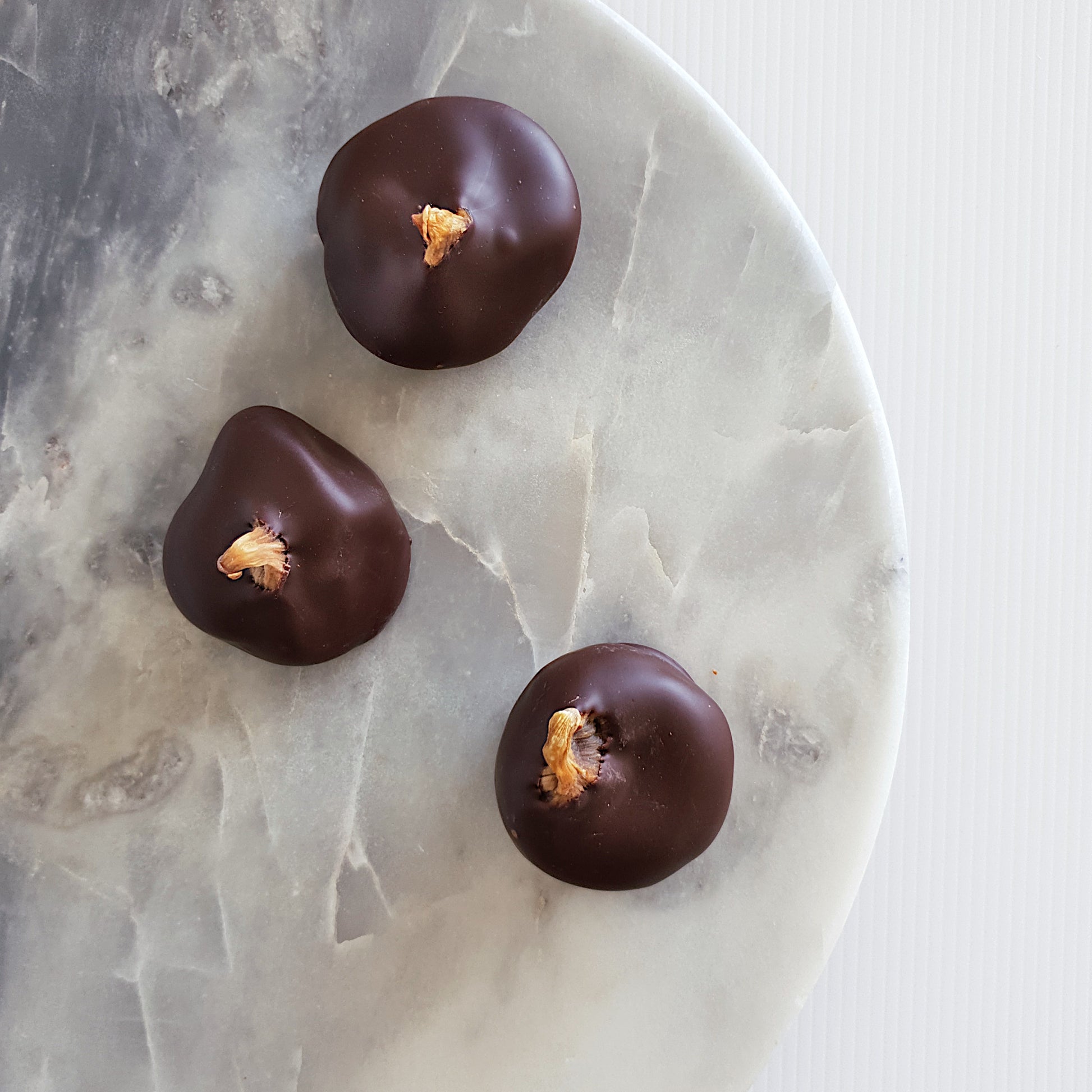 Premium Turkish figs coated with Callebaut Belgian couverture 54% dark chocolate. Available in 200g bags through Woodstock chocolate co. Handmade in Milton NSW