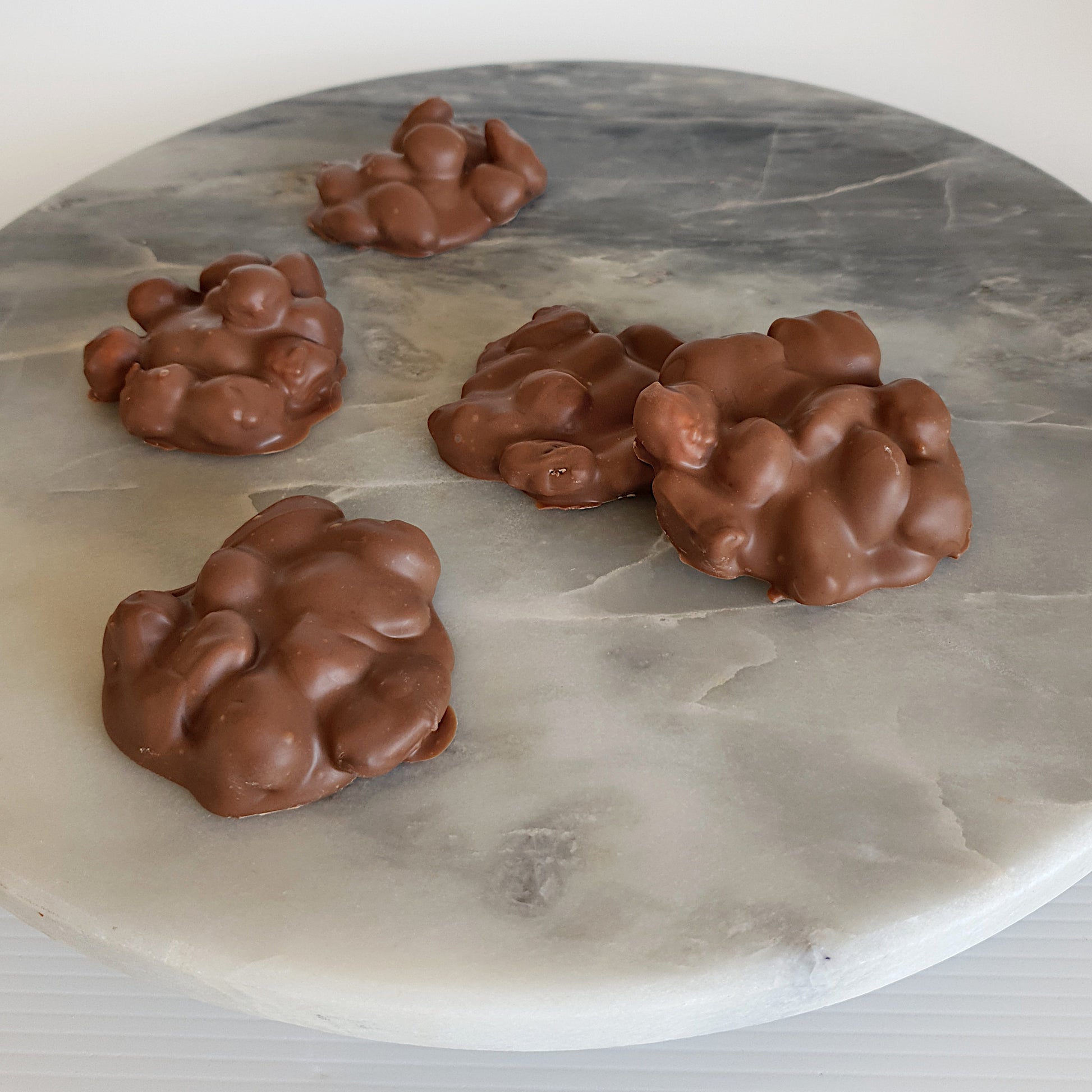 Milk chocolate nut clusters made with almonds, pistachios and hazelnuts. Made in store at Woodstock chocolate co in Milton NSW