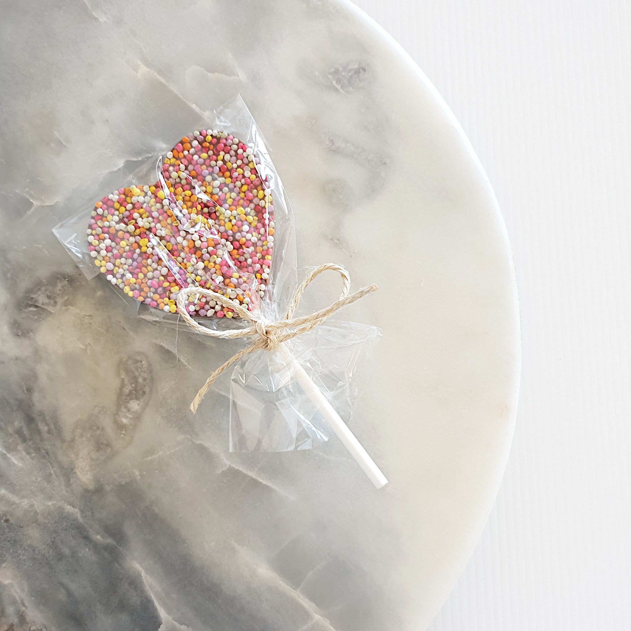 Gift idea for the kids - Belgian milk chocolate speckle lollipop - Callebaut milk chocolate heart or round lollipop decorated with hundreds and thousands. Made in Milton NSW by Woodstock chocolate co