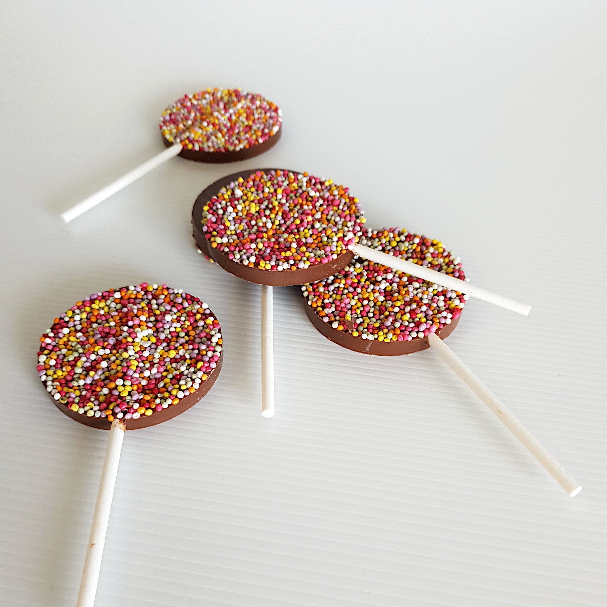 Milk chocolate lollipops topped with non-pareils. Made with Belgian chocolate by Woodstock Chocolate Co in Milton NSW