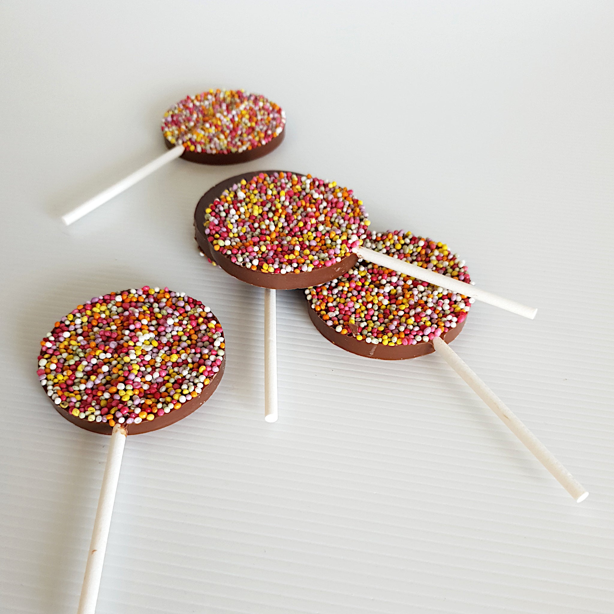 Milk chocolate lollipops topped with non-pareils. Made with Belgian chocolate by Woodstock Chocolate Co in Milton NSW