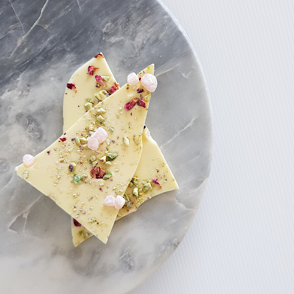 White chocolate shards topped with Turkish delight pieces, crushed pistachio and organise rose petals. Made with Callebaut Belgian couverture white chocolate in Milton NSW at Woodstock Chocolate Co.